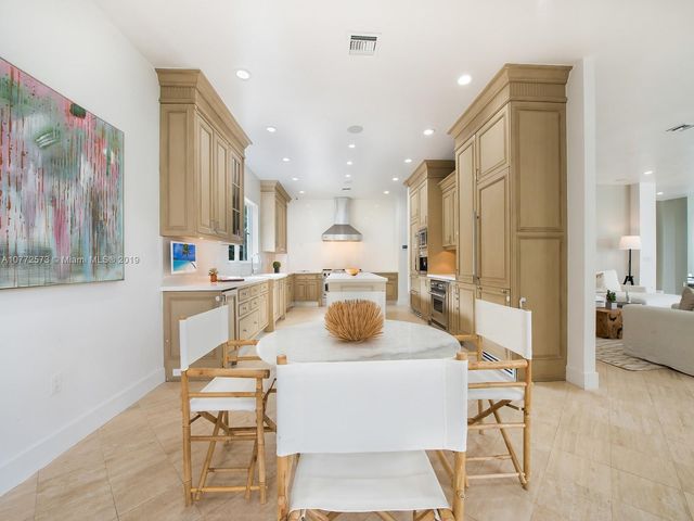 a view of a dining room with furniture and a chandelier
