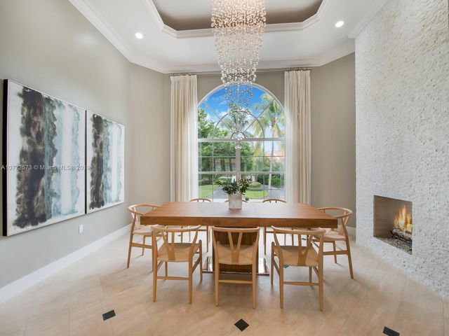 a dining room with furniture a chandelier and window