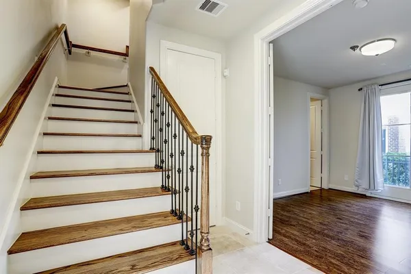 a view of entryway with wooden floor and stairs