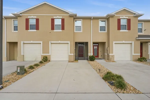 a front view of a house with a yard