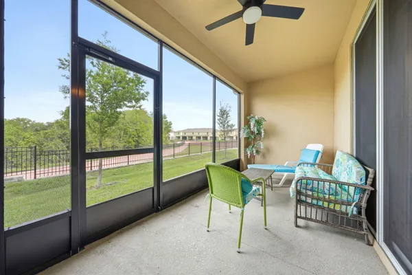 a dining room with furniture and a floor to ceiling window