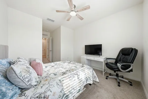 a bedroom with a bed and a chair