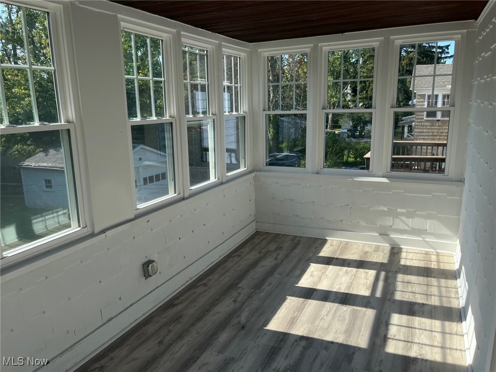 1148 Sylvania Road Cleveland Heights, OH 44121 - Photo 20 of 30 Unfurnished sunroom featuring LVT floors and plenty of light.