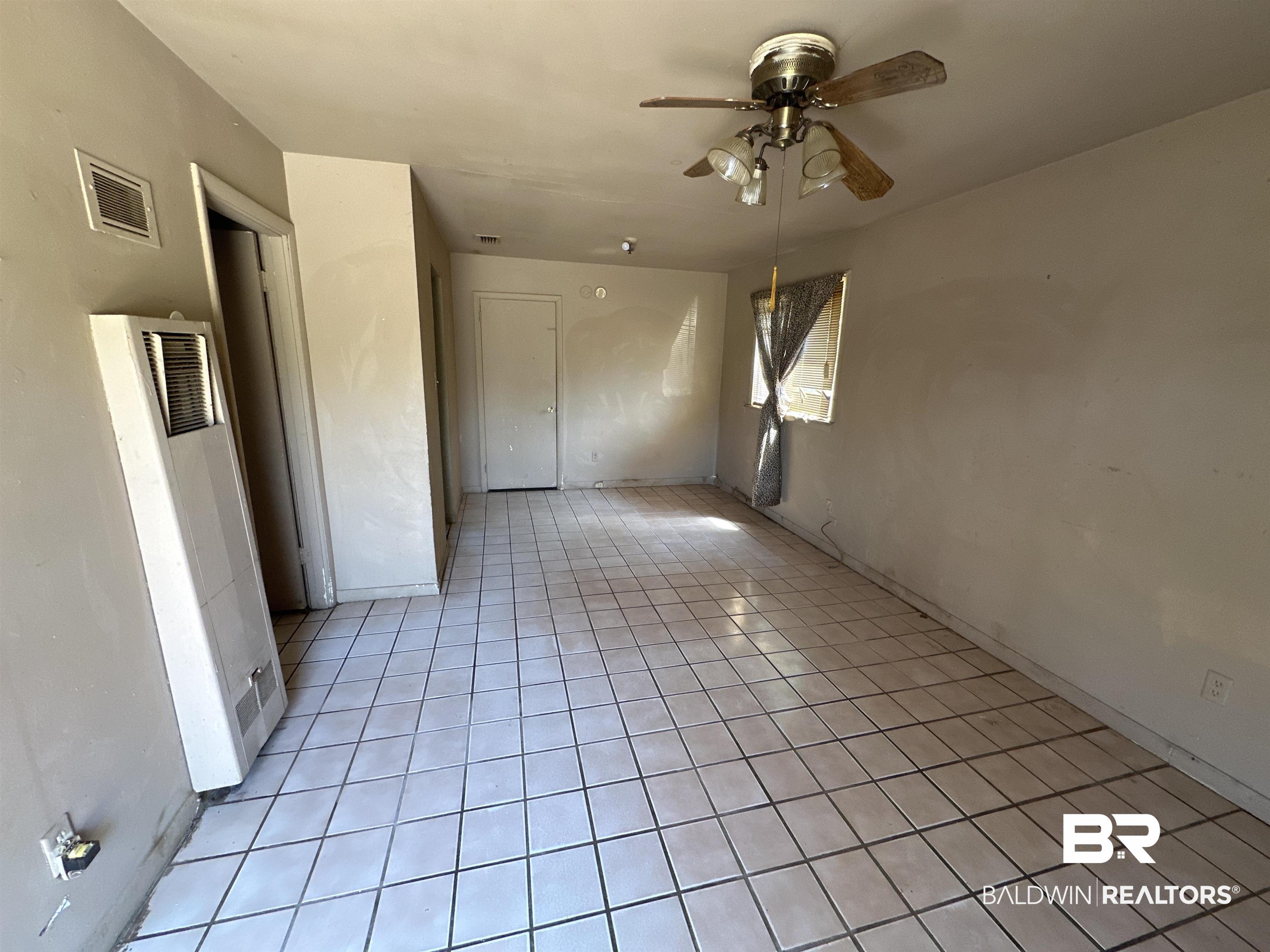 58 Chieftain Way Mobile, AL 36611 - Photo 2 of 12 Tiled empty room featuring ceiling fan