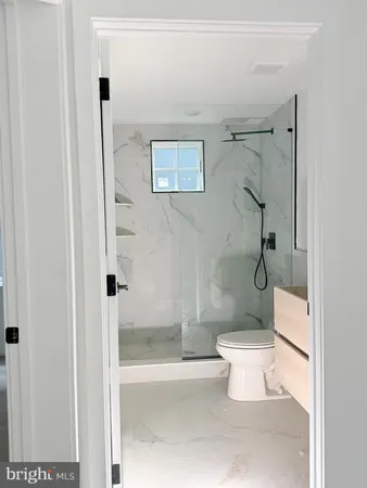 a bathroom with a toilet and shower