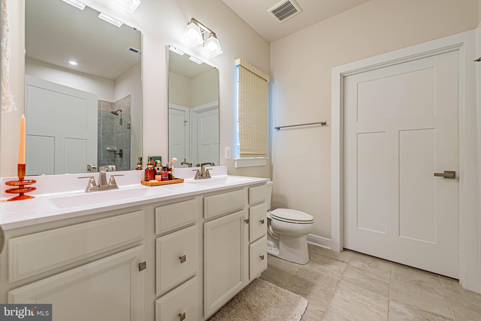 12115 Snug Harbor Road Berlin, MD 21811 - Photo 18 of 46 a bathroom with a double vanity sink mirror and toilet
