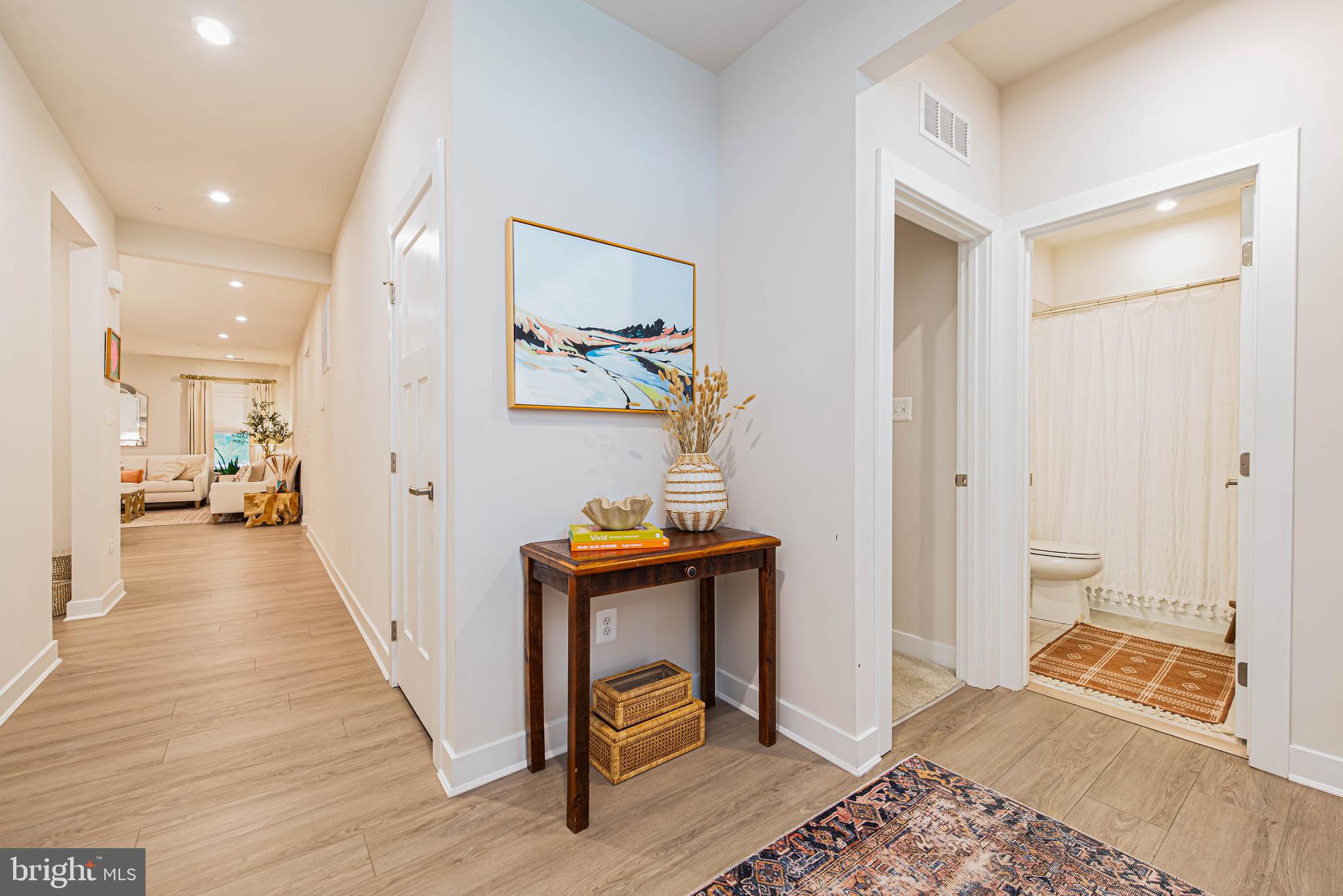 12115 Snug Harbor Road Berlin, MD 21811 - Photo 26 of 46 a view of a hallway with bathroom and wooden floor