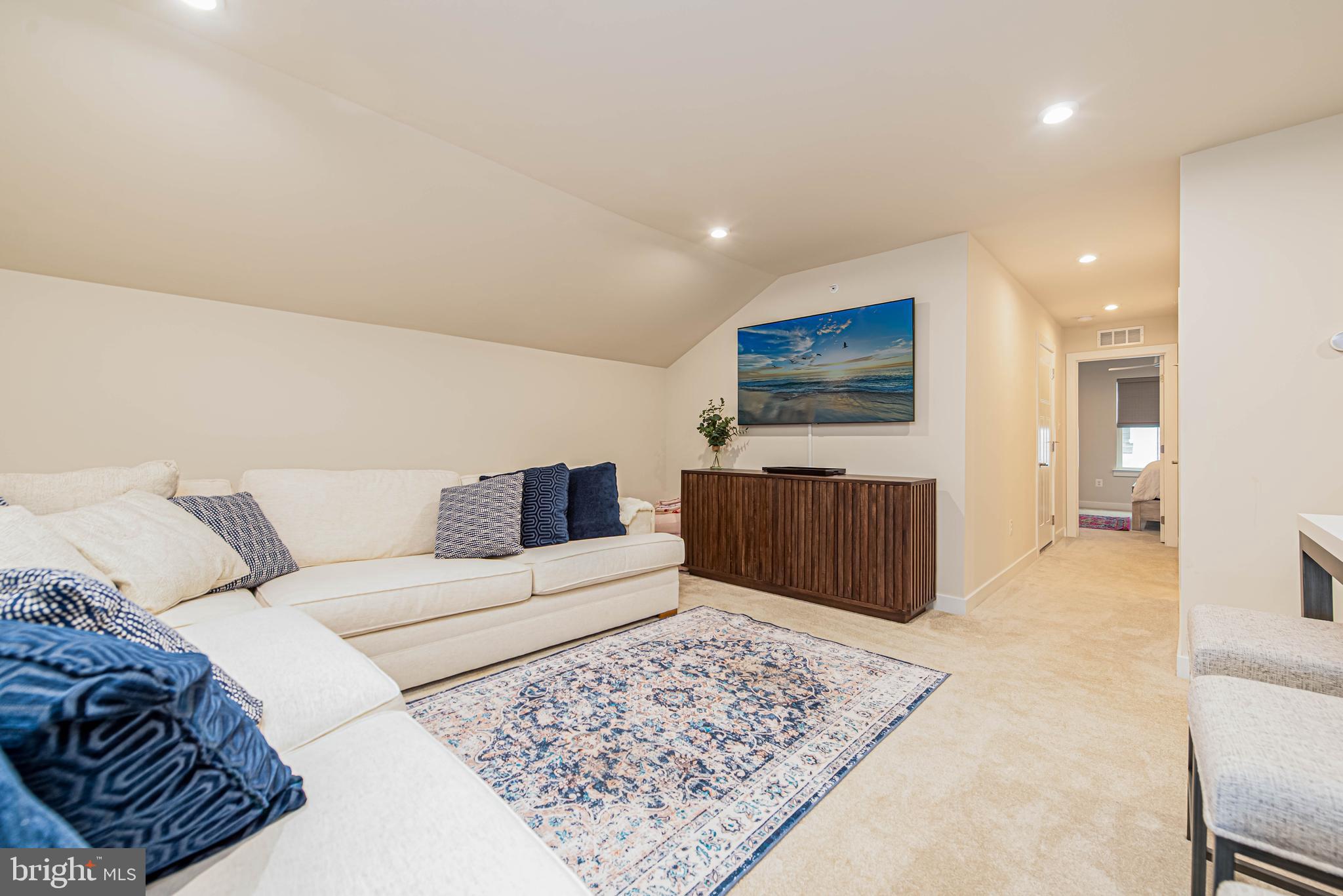 12115 Snug Harbor Road Berlin, MD 21811 - Photo 30 of 46 a living room with furniture rug and a flat screen tv