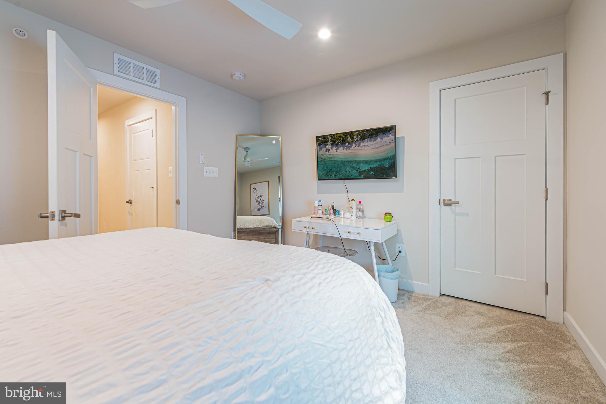 12115 Snug Harbor Road Berlin, MD 21811 - Photo 32 of 46 a bedroom with a bed and a flat screen tv