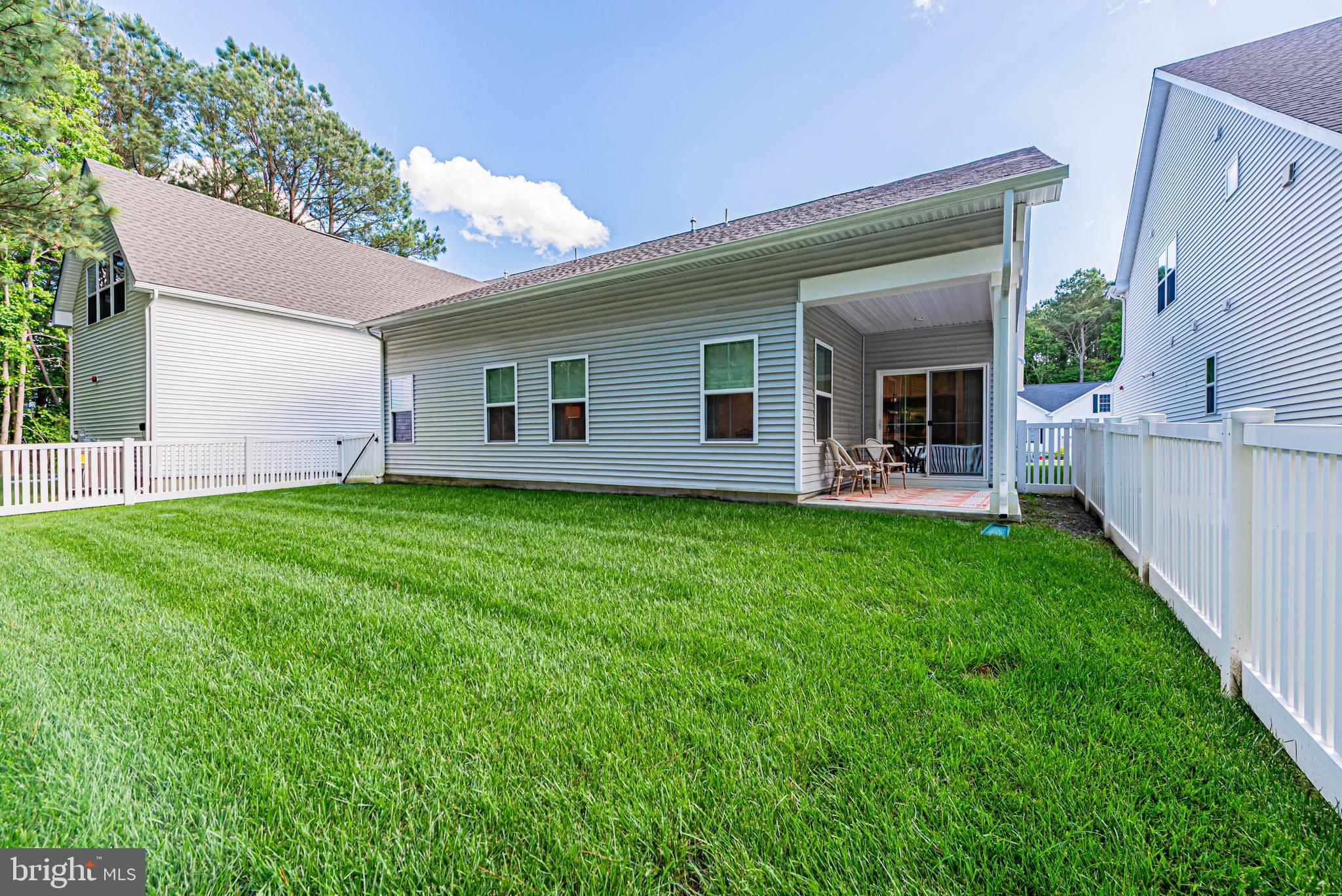 12115 Snug Harbor Road Berlin, MD 21811 - Photo 38 of 46 a backyard of a house with table and chairs