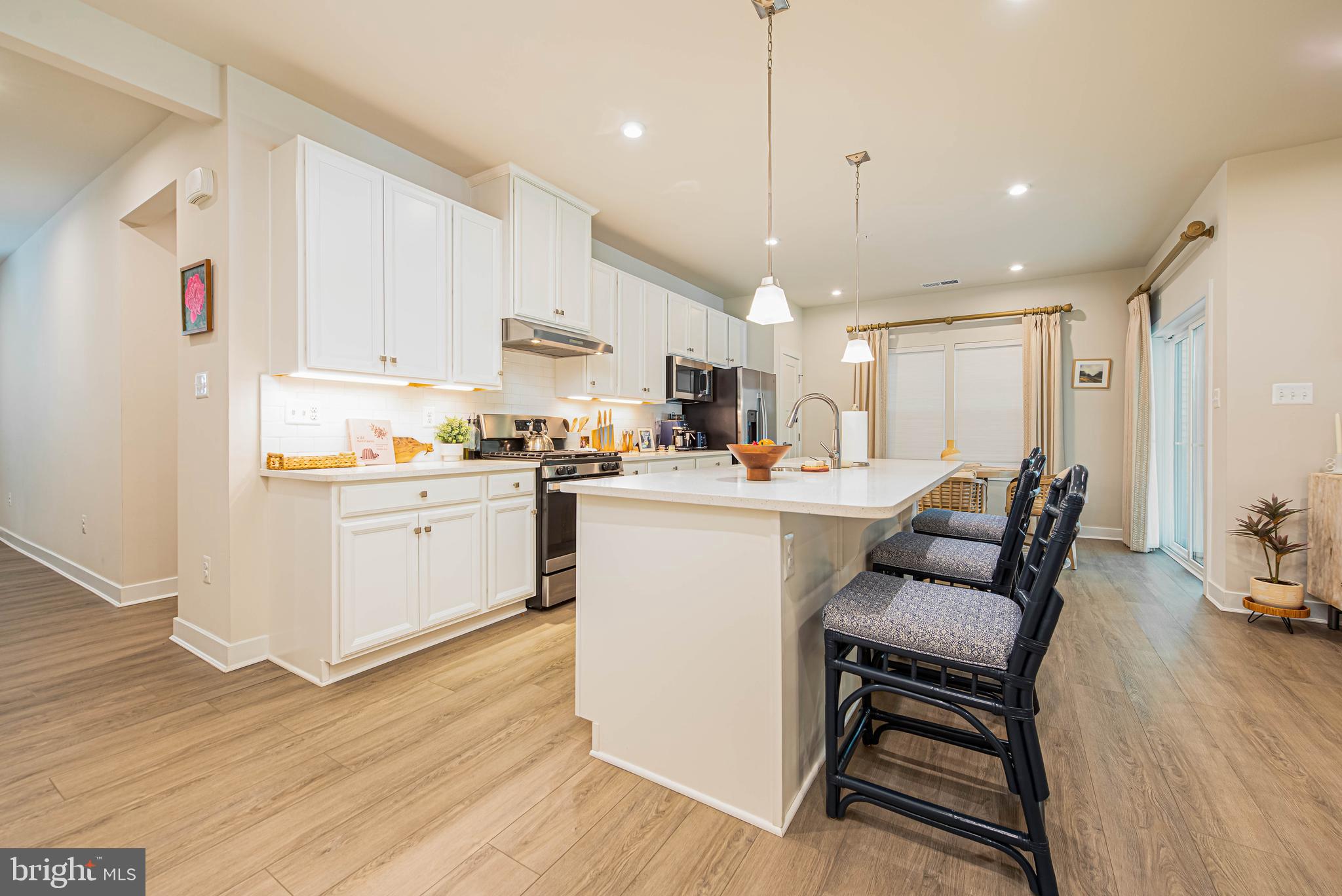 12115 Snug Harbor Road Berlin, MD 21811 - Photo 7 of 46 a kitchen with a table chairs refrigerator and cabinets