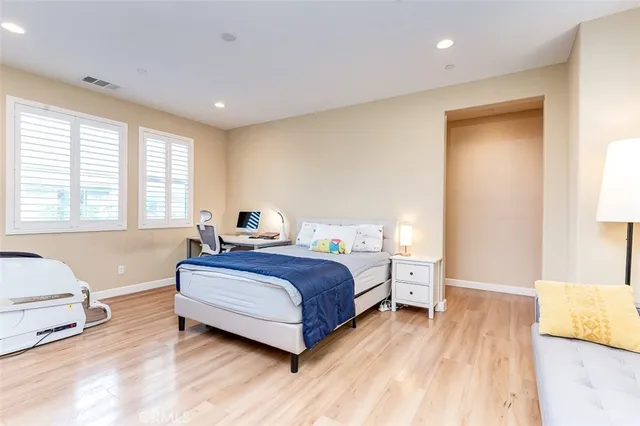 a spacious bedroom with a bed and a couch