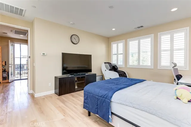 a bedroom with a bed and a flat screen television