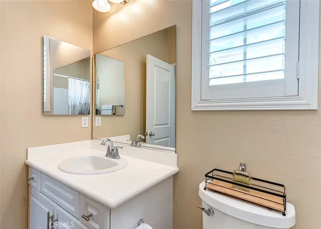 a bathroom with a sink a vanity and a window