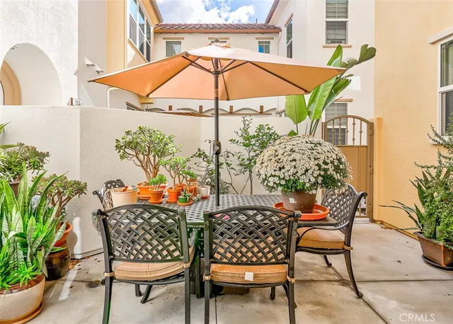 a view of a chair and tables in the balcony