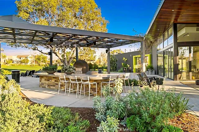 a view of a swimming pool with a lawn chairs under palm trees