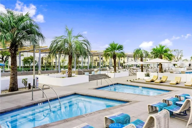 a view of a patio with table and chairs under an umbrella
