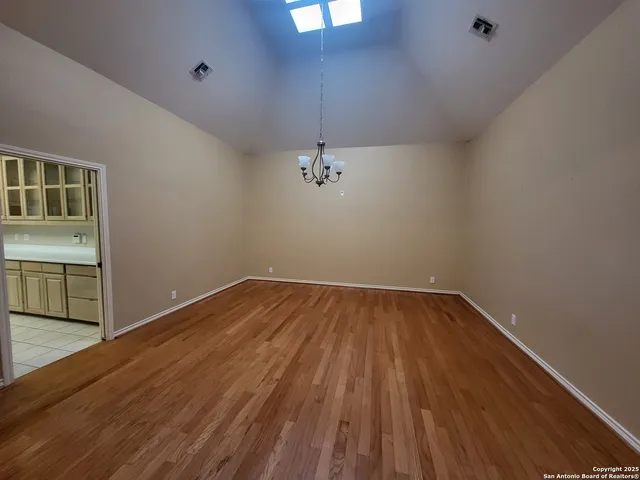 a kitchen with granite countertop a refrigerator and a stove top oven