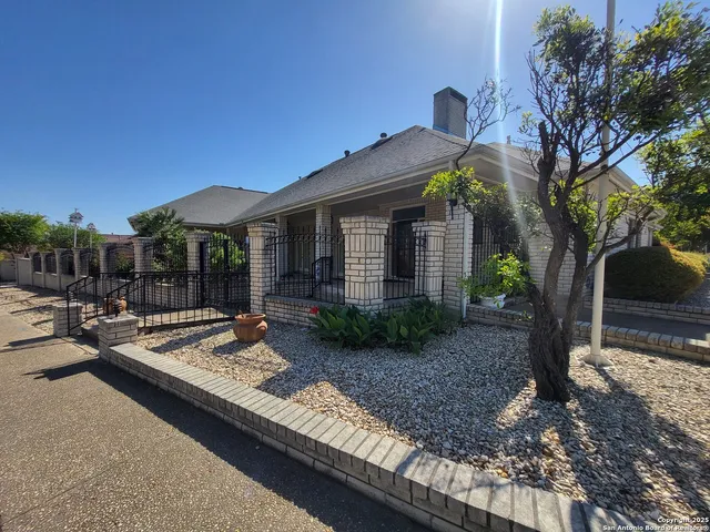 a view of a house with backyard and sitting area