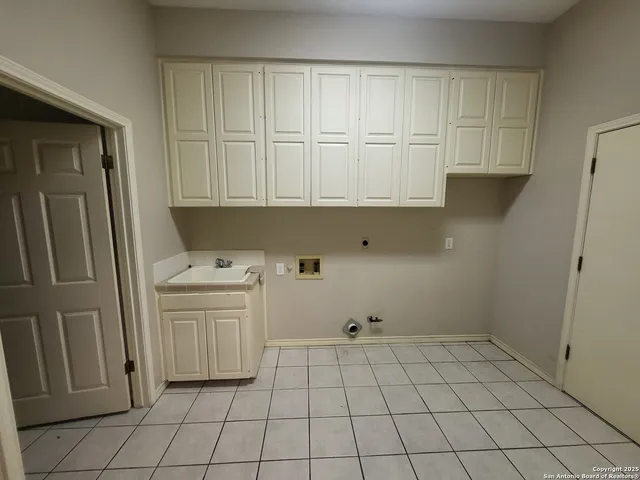 a kitchen with a sink and cabinets