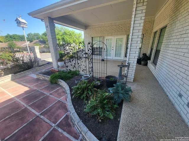 a view of a porch with furniture and garden