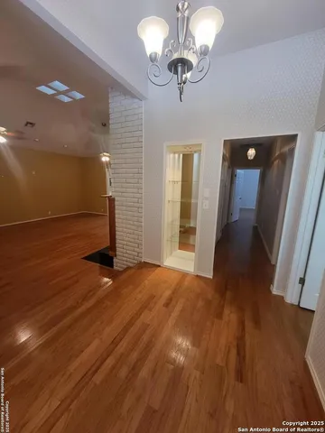 wooden floor in an empty room with a mirror