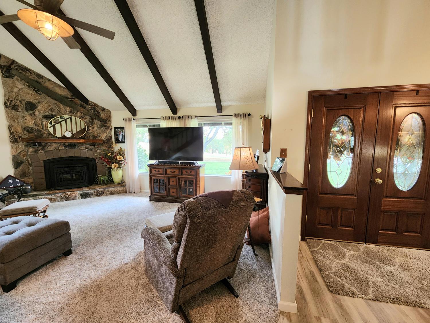 22266 Frontier Road Clovis, CA 93619 - Photo 17 of 61 a living room with furniture a flat screen tv and a fireplace