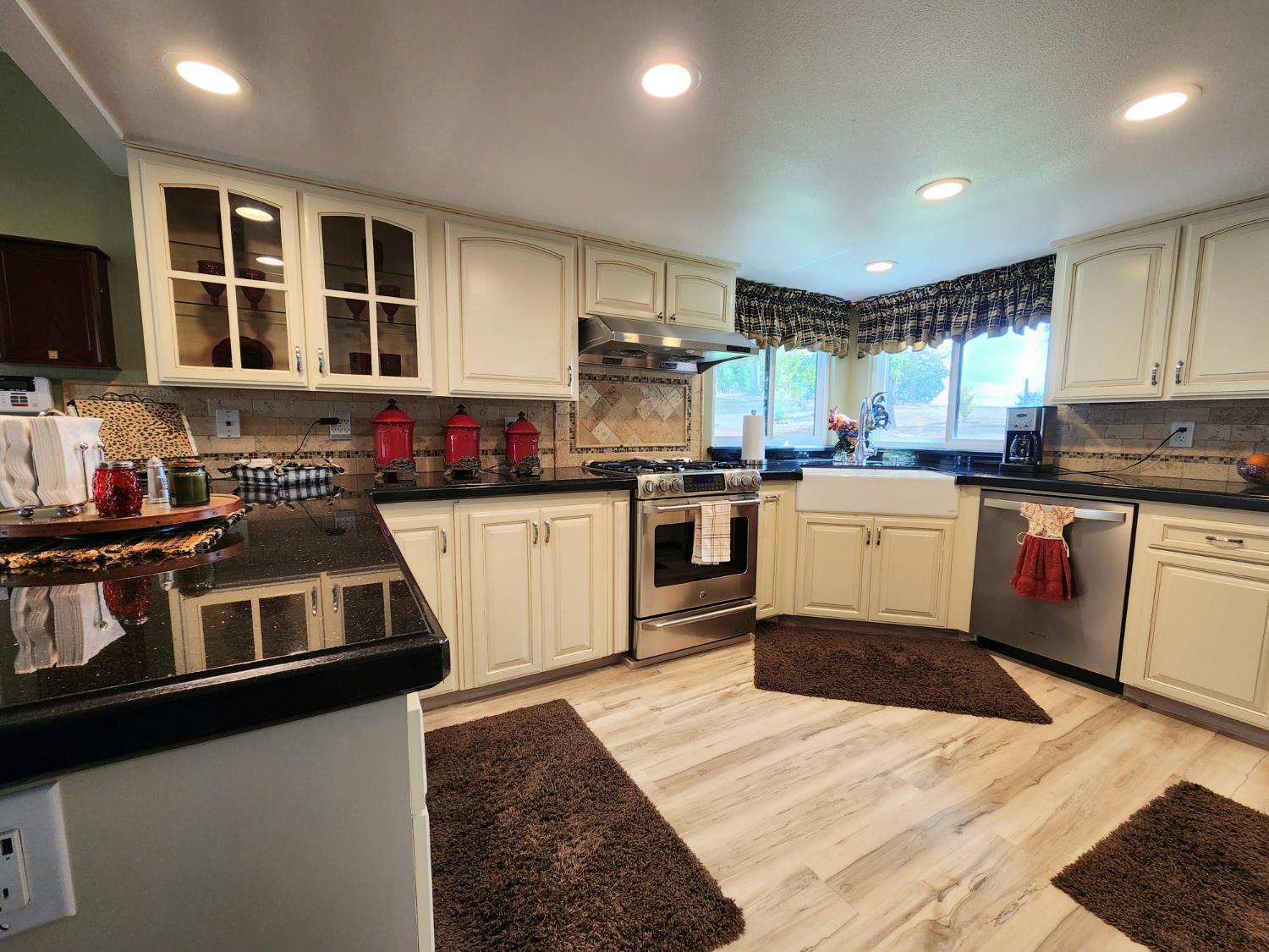 22266 Frontier Road Clovis, CA 93619 - Photo 21 of 61 a kitchen with stainless steel appliances granite countertop a stove sink and microwave