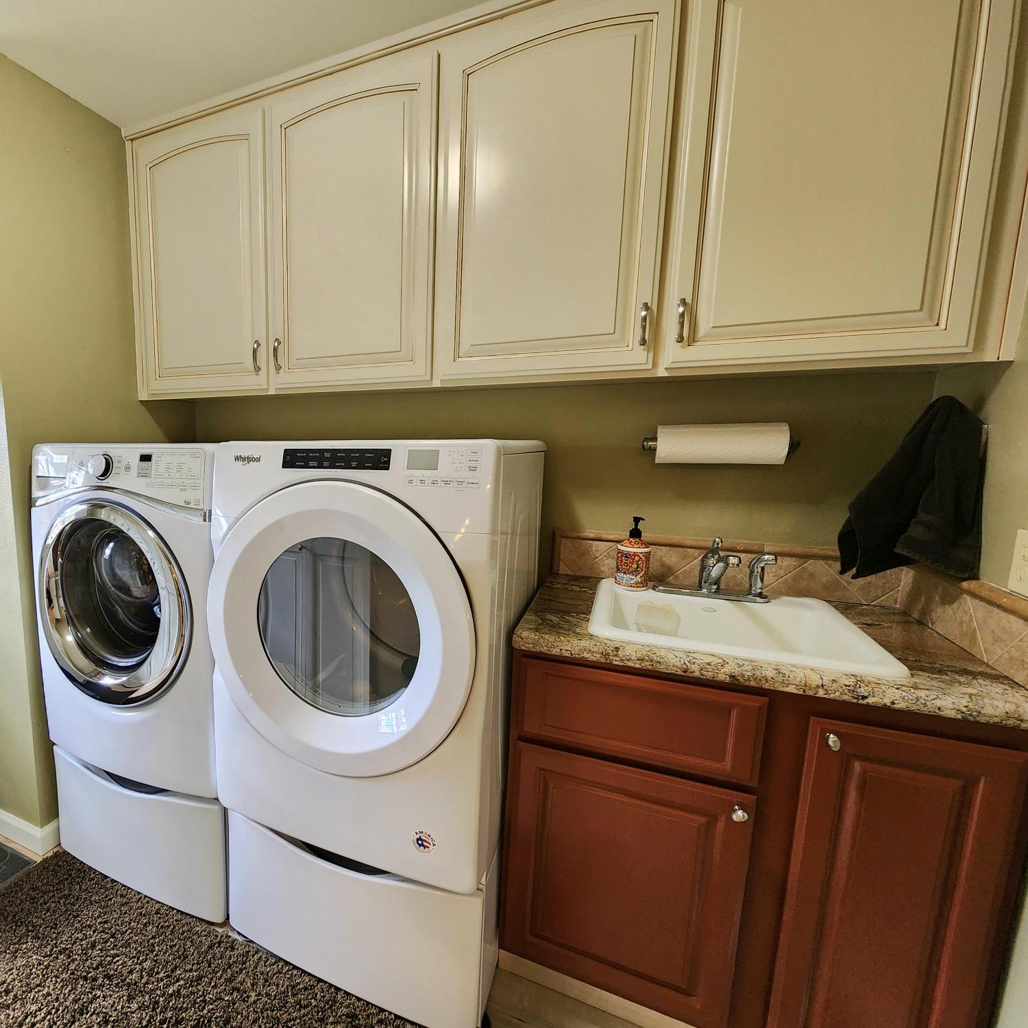 22266 Frontier Road Clovis, CA 93619 - Photo 25 of 61 a utility room with granite countertop white cabinets and washer