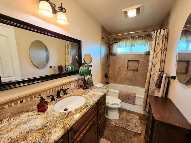 a view of a house with a tree and a yard