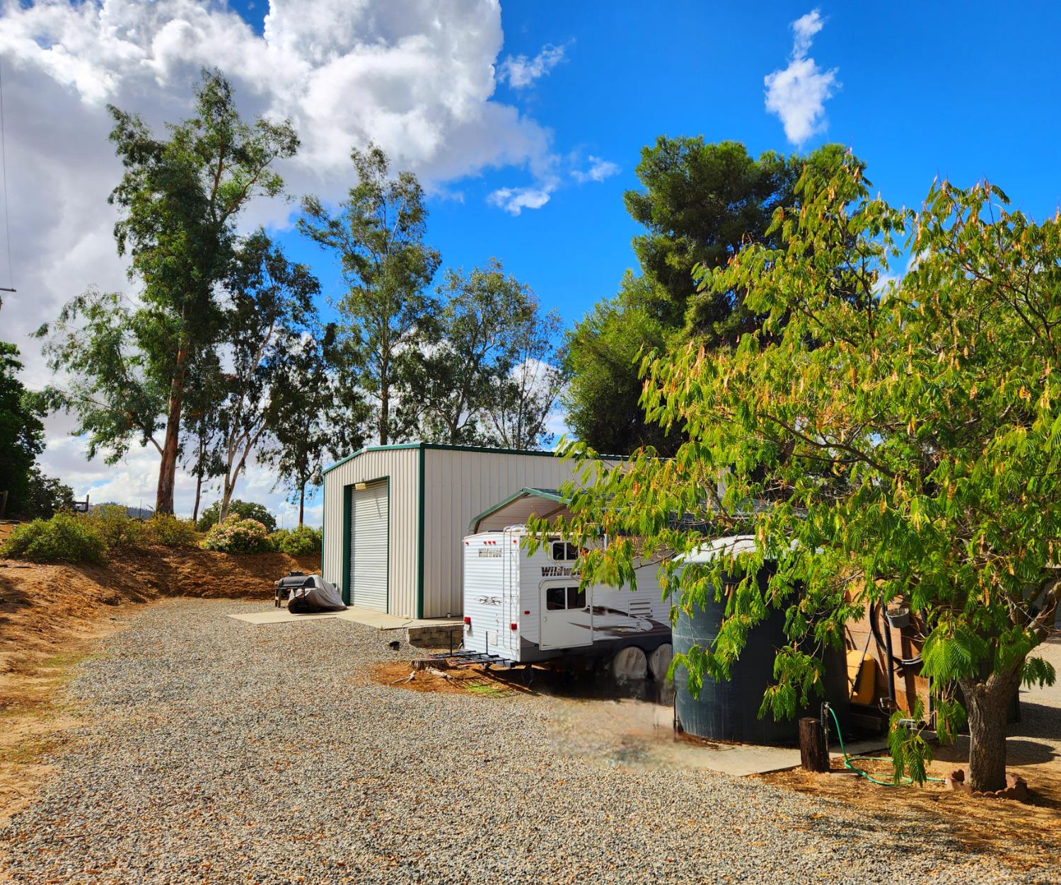 22266 Frontier Road Clovis, CA 93619 - Photo 36 of 61 a view of a house with a tree and a yard