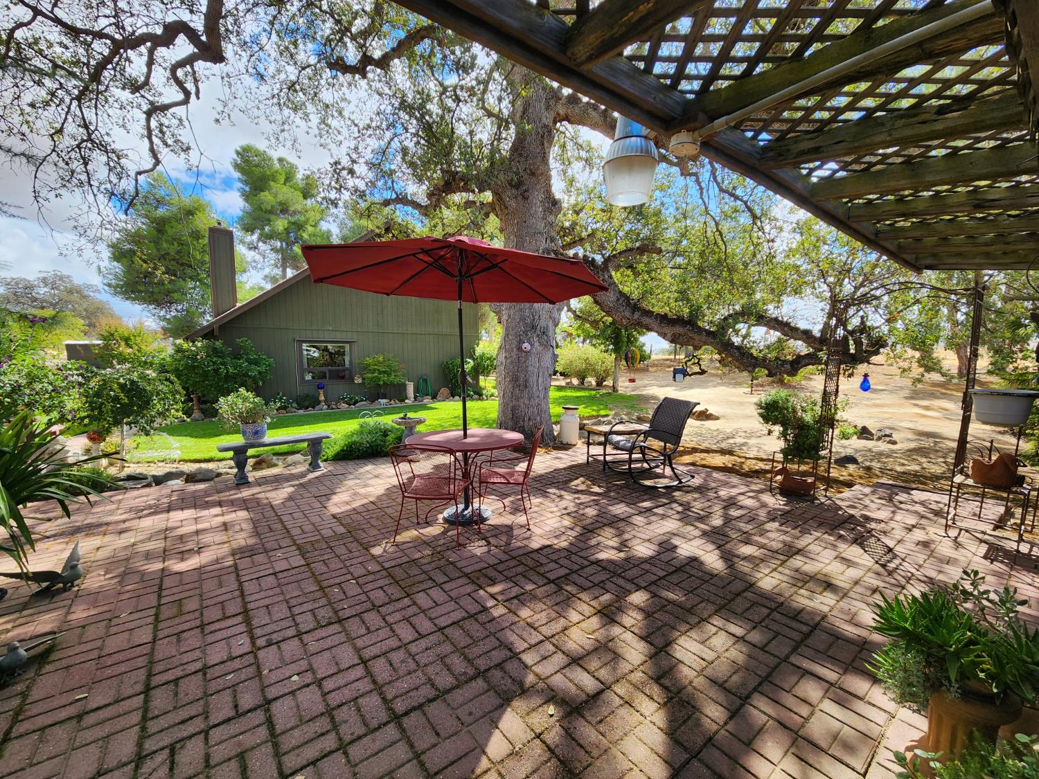 22266 Frontier Road Clovis, CA 93619 - Photo 42 of 61 a view of a table and chairs under an umbrella in the patio