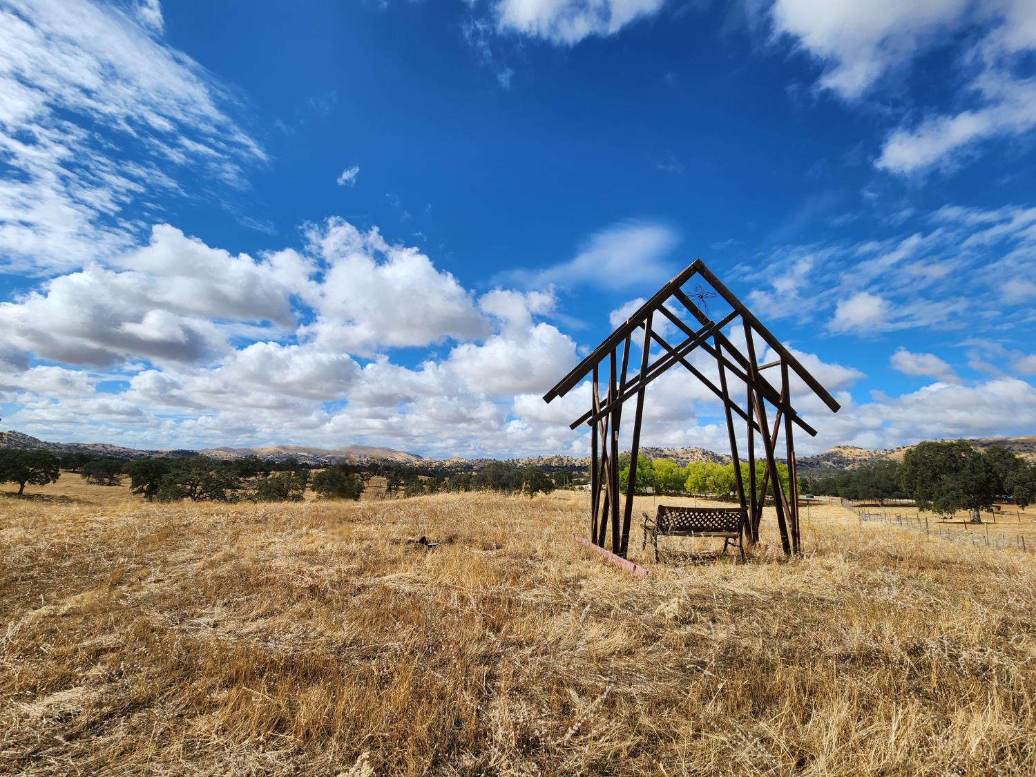 22266 Frontier Road Clovis, CA 93619 - Photo 46 of 61 a view of a lake with a bench in the background