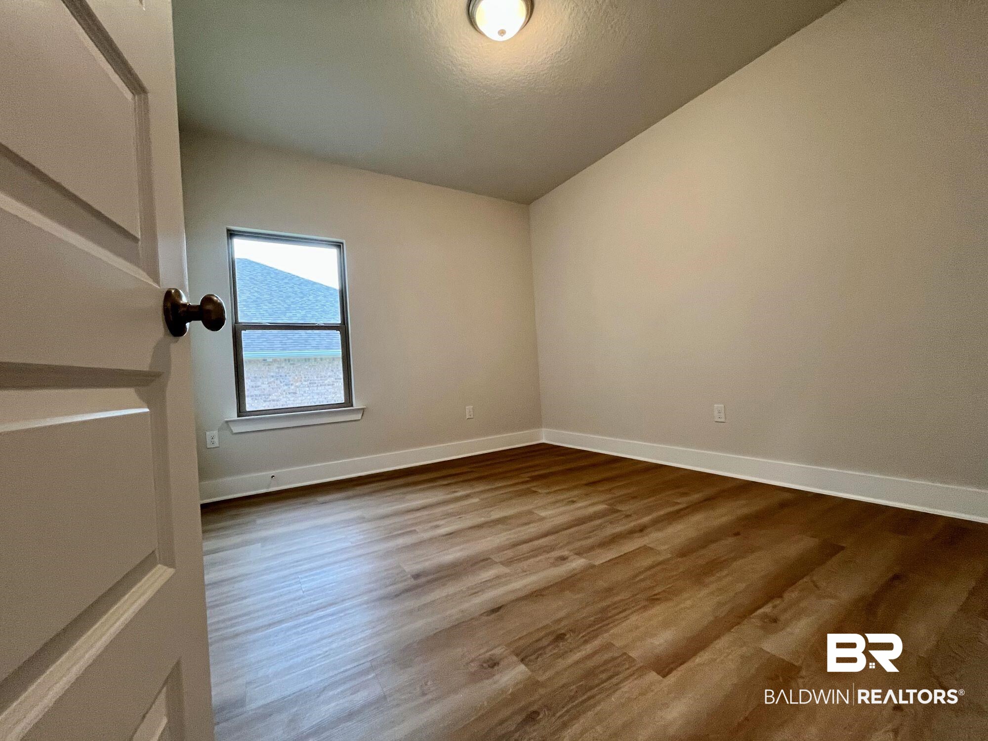 330 Barndling Street Fairhope, AL 36532 - Photo 22 of 31 Unfurnished room with vaulted ceiling and hardwood / wood-style flooring