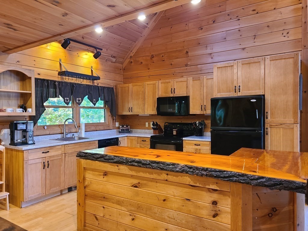 118 Town Farm Road Brookfield, MA 01506 - Photo 7 of 26 a kitchen with stainless steel appliances wooden cabinets a sink and a stove