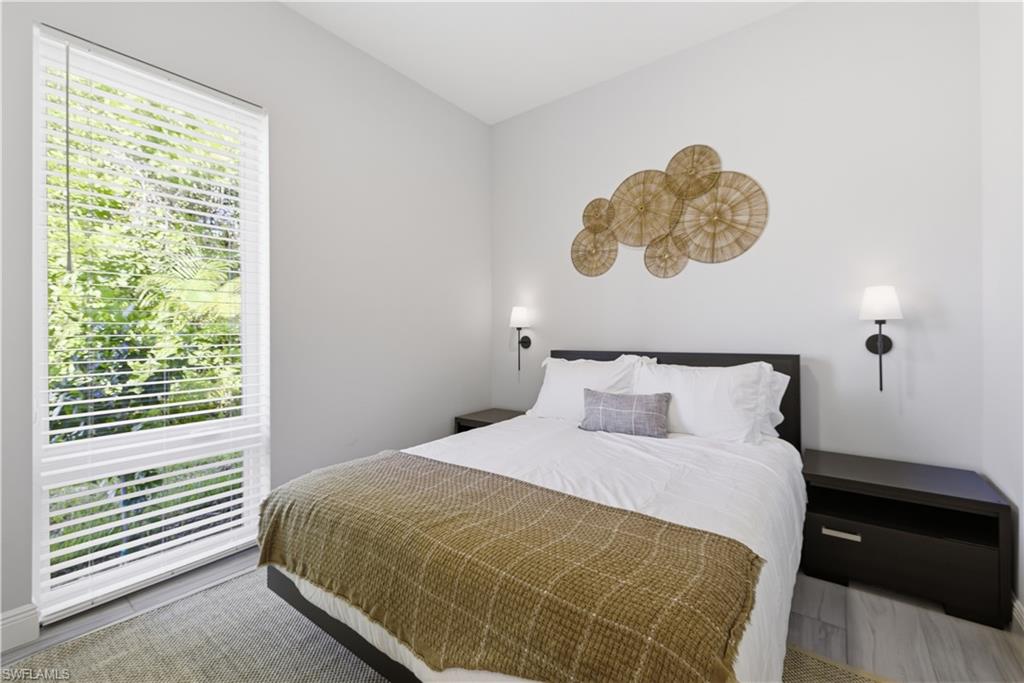 711 91st Avenue North Naples, FL 34108 - Photo 14 of 29 a bedroom with a bed and a window