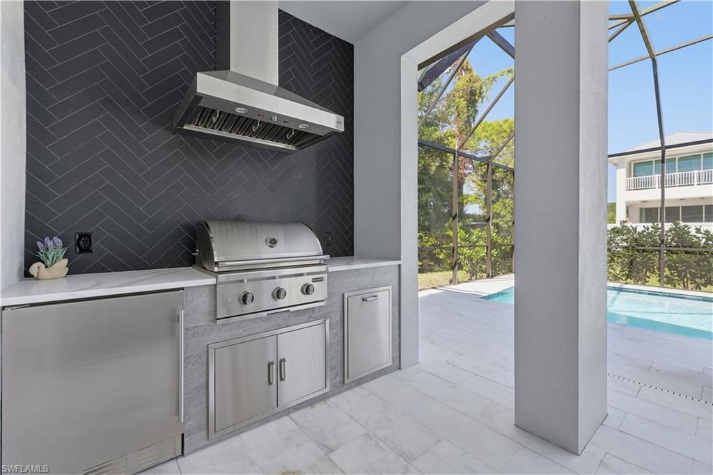 711 91st Avenue North Naples, FL 34108 - Photo 23 of 29 a kitchen with white cabinets and a stove