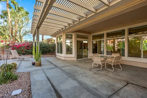 a patio with yard glass top table and chairs
