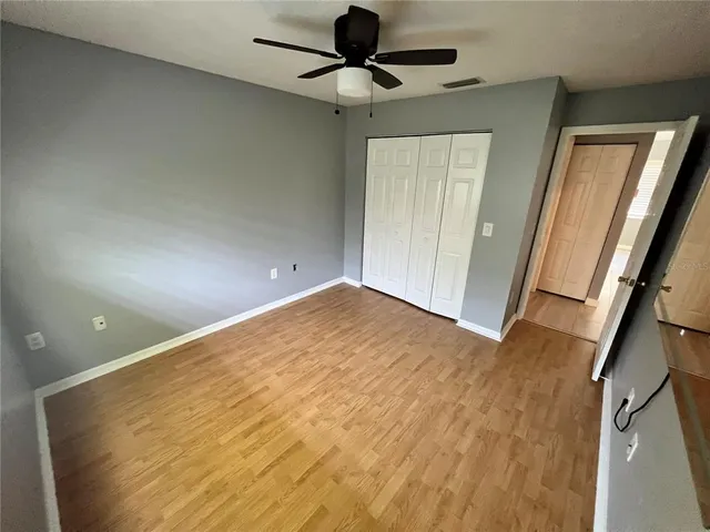 a view of empty room with wooden floor