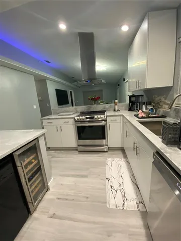a kitchen with a sink stainless steel appliances and cabinets