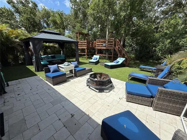 a view of a backyard with sitting area and furniture