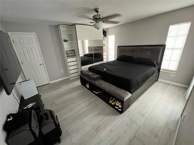 a bedroom with a bed and a chandelier