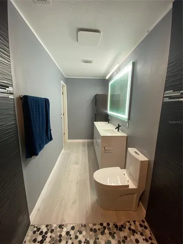 a bathroom with a toilet and a mirror