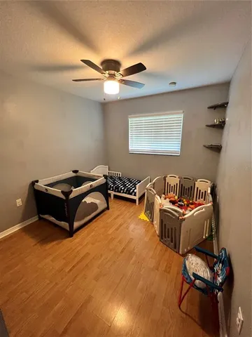 a living room with furniture and a ceiling fan