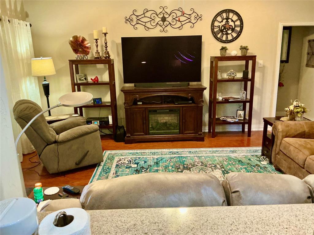 312 McAfee Street Mabank, TX 75147 - Photo 23 of 40 a living room with furniture and a flat screen tv