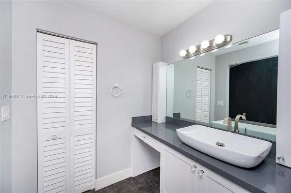 a bathroom with a double vanity sink and a mirror