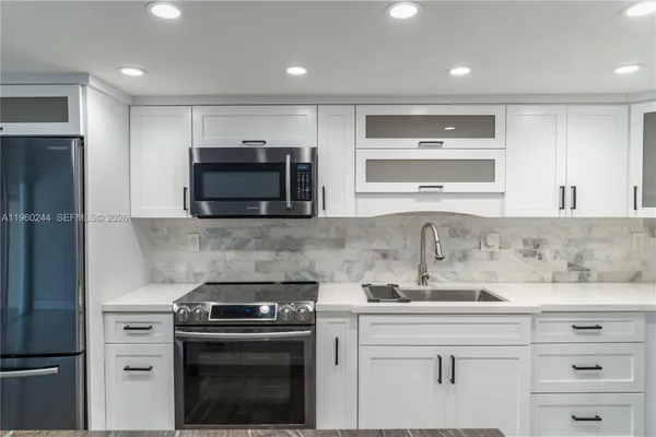 a kitchen with a stove and a sink