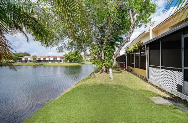 a view of a patio with table and chairs next to a yard