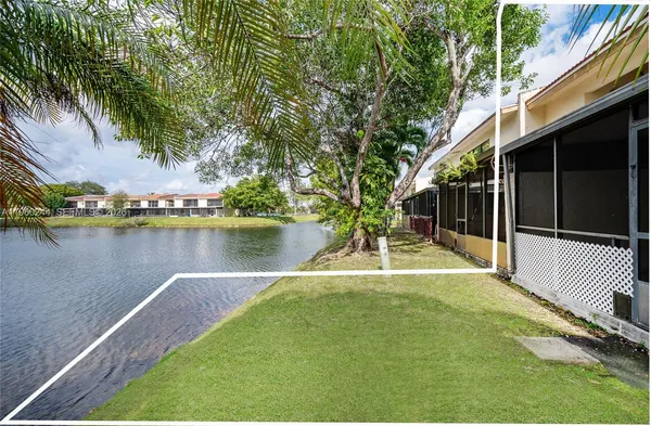a view of a swimming pool with a patio and a yard