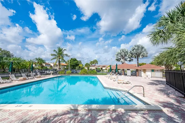 a view of swimming pool with outdoor seating and plants